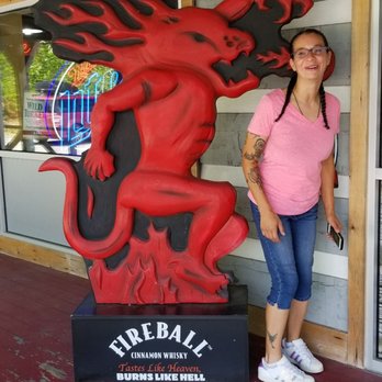 The Liquor Barn - a woman standing in front of a red dragon statue - Beer, Wine & Spirits Near Me - Caryville, Tennessee