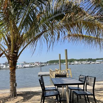 Bowleys On The Bay - a table and chairs on the beach - New American Near Me - Middle River, Maryland Bowleys On The Bay - a table and chairs on the beach - New American Near Me - Middle River, Maryland