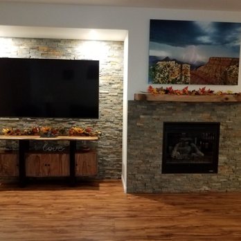 Tri-City Home Improvement Pros - a living room with a fireplace and a flat screen tv - General Contractors Near Me - Prescott, Arizona