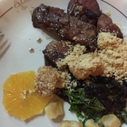 Classic Feijoada - salted, sun-dried meats, stewed black beans, orange slices, bitter greens, manioc flour, pork chicharones, white rice