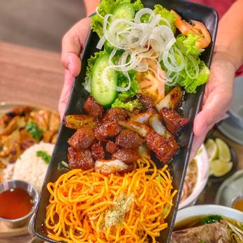Mr Pho California Kitchen - a person holding a tray of food - Vietnamese Near Me - Walnut, California Mr Pho California Kitchen - a person holding a tray of food - Vietnamese Near Me - Walnut, California