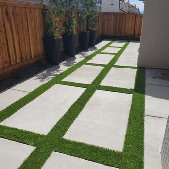 Three Lions Landscape - Artificial turf, compact gravel base, lava rock along fence with small plants accenting - Landscaping Near Me - Antioch, California