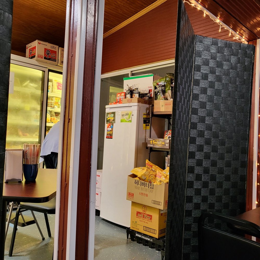 a kitchen with a refrigerator and table a kitchen with a refrigerator and table