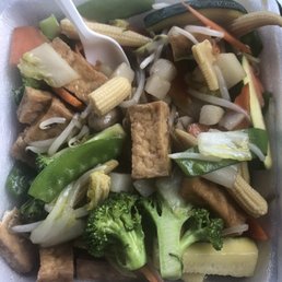 tofu and vegetables in a takeout container