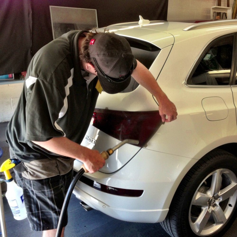 Tinteks - Using a modified garment steamer to heat film to wrap perfectly. - Auto Glass Services Near Me - Parker, Colorado