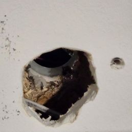 Incorrect hole made through garage wall & stucco. Incorrect hole made through garage wall & stucco.