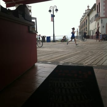 Pisa Pizza - a person walking on a boardwalk - Pizza Near Me - Ocean City, New Jersey Pisa Pizza - a person walking on a boardwalk - Pizza Near Me - Ocean City, New Jersey