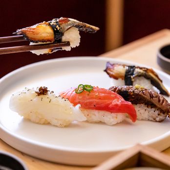 Neighborhood Sushi - a plate of sushi with chopsticks - Japanese Near Me - Austin, Texas Neighborhood Sushi - a plate of sushi with chopsticks - Japanese Near Me - Austin, Texas