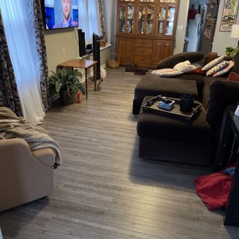 Falcon Renovations - a living room with a flat screen tv - Flooring Near Me - Rochester, New York