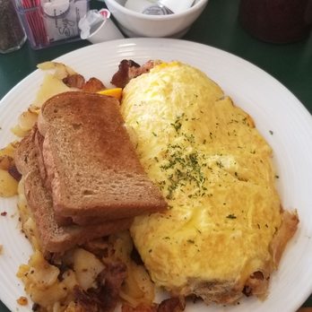The Frog Pond - Club Omelet ... Comes with home potatoes or grits and 3 type of bread, white wheat and rye. Filled with meat. - Breakfast & Brunch Near Me - St Pete Beach, Florida