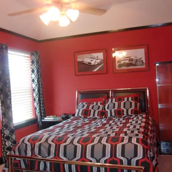 Painting Specialist - a bedroom with red walls and black accents - Painters Near Me Painting Specialist - a bedroom with red walls and black accents - Painters Near Me