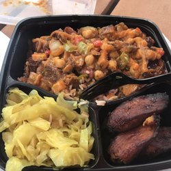 Irie Jamaican Kitchen - Oxtail Jamaican Box with Buddha Veggies and fire sauce. Left is cabbage and right is plantains.