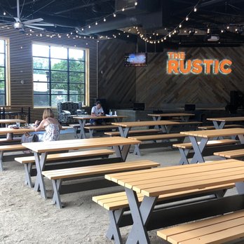 The Rustic - Love the outside is inside picnic table area around the music stage - Venues & Event Spaces Near Me - Houston, Texas