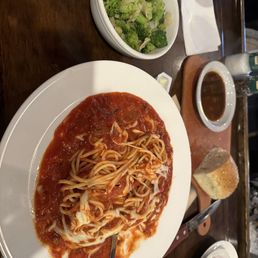 Spaghetti swimming in sauce plus note the dirty plates to right that just sat there.