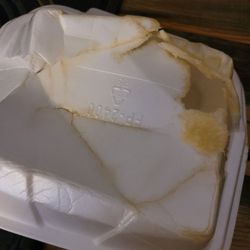 Orient Wok Chinese Cafe - Underside of melted styrofoam box.