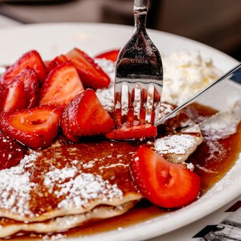 Bessie's Diner - a plate of pancakes with strawberries and powdered sugar - New American Near Me - Janesville, Wisconsin Bessie's Diner - a plate of pancakes with strawberries and powdered sugar - New American Near Me - Janesville, Wisconsin