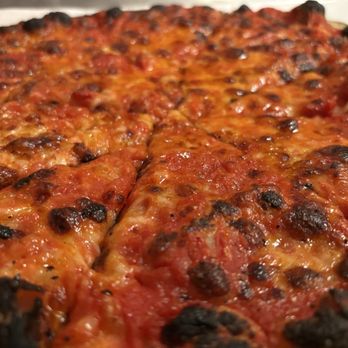 Sally's Apizza - Close-up of mozzarella and tomato sauce pie - Pizza Near Me - New Haven, Connecticut