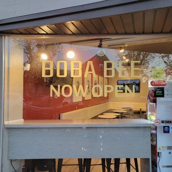 Boba Bee - The image shows a glass storefront window with a sign that reads 'BOBA BEE NOW OPEN,' indicating the business is newly opened. - Bubble Tea Near Me - Provo, Utah