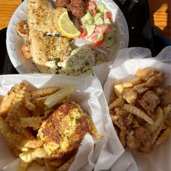 Waterfront Seafood Shack - Top plate is the flounder and shrimp combo dinner, bottom left is crab cake basket and bottom right is shark basket - Seafood Near Me - Calabash, North Carolina Waterfront Seafood Shack - Top plate is the flounder and shrimp combo dinner, bottom left is crab cake basket and bottom right is shark basket - Seafood Near Me - Calabash, North Carolina