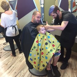 Great Clips - Our stylist working his magic with my toddler