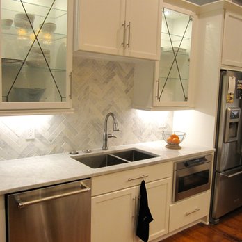 Main Street Renovations - a kitchen with white cabinets and stainless steel appliances - General Contractors Near Me - Carnegie, Pennsylvania