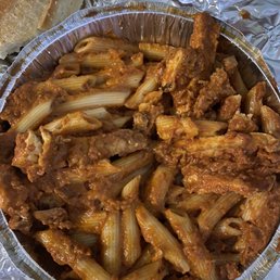 a bowl of pasta and a loaf of bread a bowl of pasta and a loaf of bread
