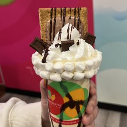 a hand holding a milkshake a hand holding a milkshake