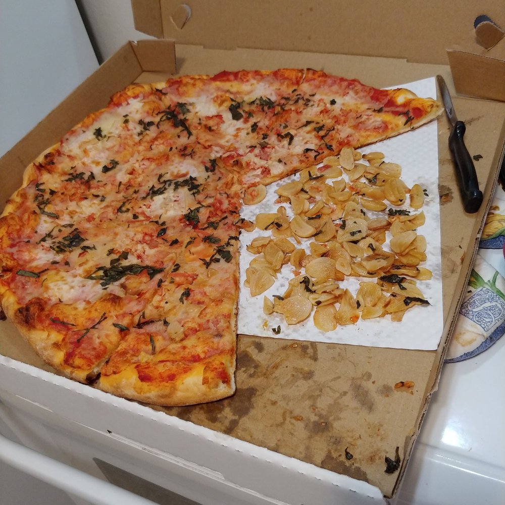 NYC Pizzeria - Pizza showing how much garlic they added to my pizza.  I ate 2 slices FULL of garlic b4 realizing too much!!!! - Pizza Near Me - Vancouver, Washington