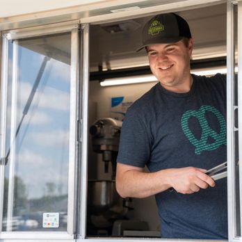 Pretzelvania - a man standing in a food truck - Food Trucks Near Me