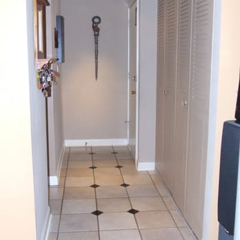 Bartler Marble,Tile and More - a hallway with a clock on the wall - Flooring Near Me - Antioch, Illinois