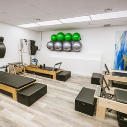 Conscious Core Pilates - Four stations each with Balanced Body reformer, tower, mat, chair and props.