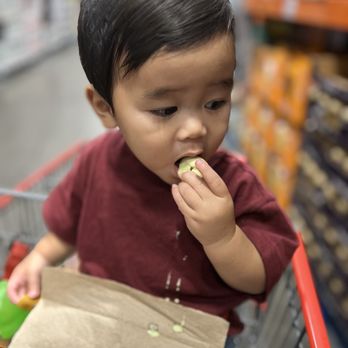 Costco Wholesale - Little man making a mess but loving the sample. - Wholesale Stores Near Me - Tigard, Oregon Costco Wholesale - Little man making a mess but loving the sample. - Wholesale Stores Near Me - Tigard, Oregon