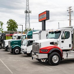 TrailerCraft - A lineup of heavy duty vehicles at TrailerCraft, including Weatern Star and Freightliner trucks.