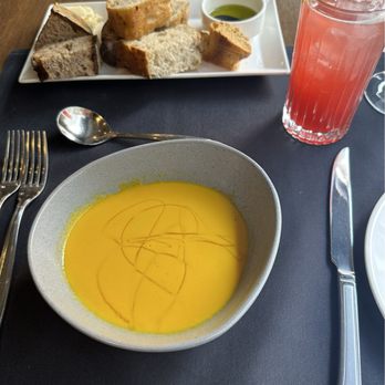 Panzano - Warm, fresh bread with olive oil, cream of carrot soup, and a sun splash - Italian Near Me - Denver, Colorado Panzano - Warm, fresh bread with olive oil, cream of carrot soup, and a sun splash - Italian Near Me - Denver, Colorado