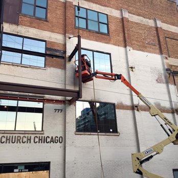 Green Building Partners - a man on a cherry picker - General Contractors Near Me - Chicago, Illinois Green Building Partners - a man on a cherry picker - General Contractors Near Me - Chicago, Illinois