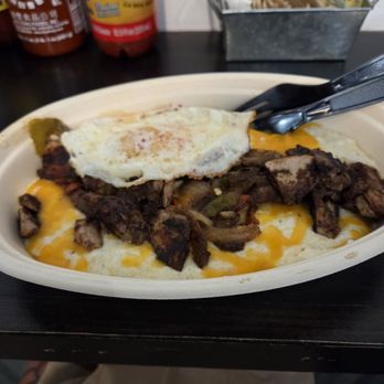 The West Egg - Chef spacial this day, Jerk Chicken over perfectly grits, cheese, marinated onions and peppers and an over Easy egg.  So good. - Coffee & Tea Near Me - St. Augustine, Florida