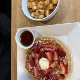 Topped waffle with strawberries & breakfast potatoes