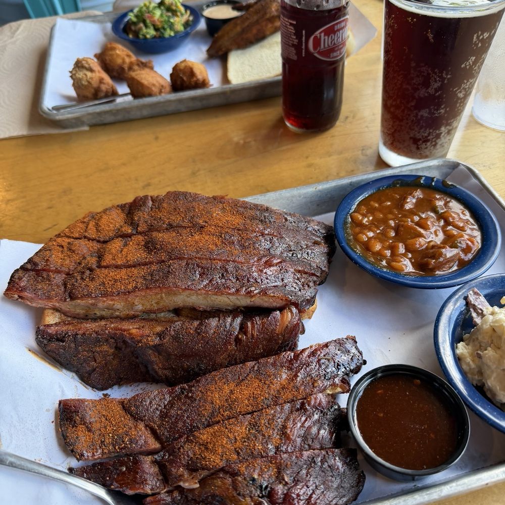 Ribs half rack with baked beans and potato salad. 1/4 chicken with hush puppies and broccoli salad.