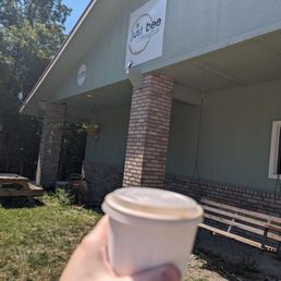a hand holding a cup of coffee