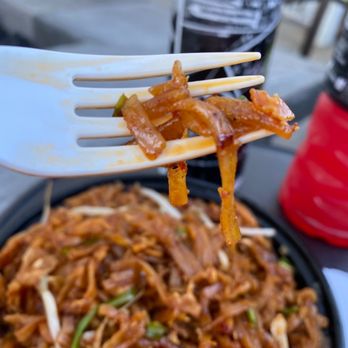 Rock N Thai Cafe - a fork lifting up some food - Thai Near Me - Holland, Michigan
