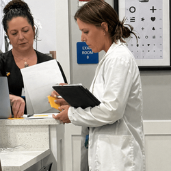 Make You Well, Colleyville - Coordinated primary care team at Make You Well Colleyville, reviewing patient charts for same-day treatment decisions