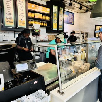 Potbelly Sandwich Shop - Three employees standing around while one employee works - Sandwiches Near Me - Charlotte, North Carolina