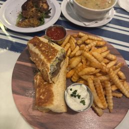 Shawarma wrap with fries, soup and a skewer of chicken Shawarma wrap with fries, soup and a skewer of chicken