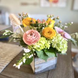 "Lovey-Dovey": ranunculus, roses, hydrangea, orchids, and thistle. "Lovey-Dovey": ranunculus, roses, hydrangea, orchids, and thistle.