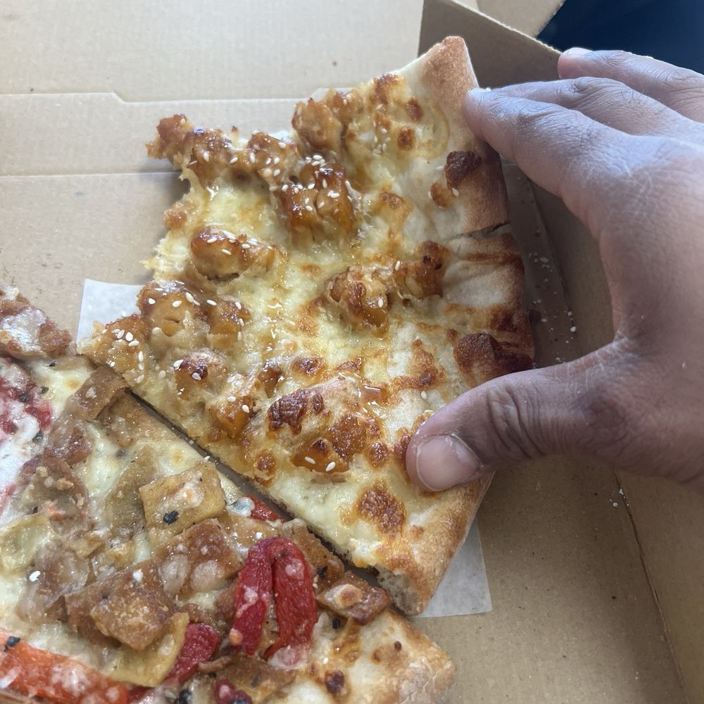 Nicolo's Pizzeria - Old Bridge - a hand grabbing a slice of pizza - Pizza Near Me - Old Bridge, New Jersey Nicolo's Pizzeria - Old Bridge - a hand grabbing a slice of pizza - Pizza Near Me - Old Bridge, New Jersey