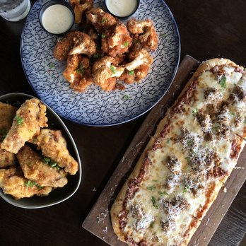 Common Theory - Chicken Wings, buffalo cauliflower and sausage flatbread - Gastropubs Near Me - San Diego, California