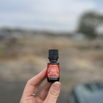 Mill Creek Natural Foods - a hand holding a bottle of essential oil - Health Markets Near Me - Union Gap, Washington Mill Creek Natural Foods - a hand holding a bottle of essential oil - Health Markets Near Me - Union Gap, Washington