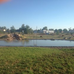 Critter Camp Bark Park - The pond with the agility courses behind it.