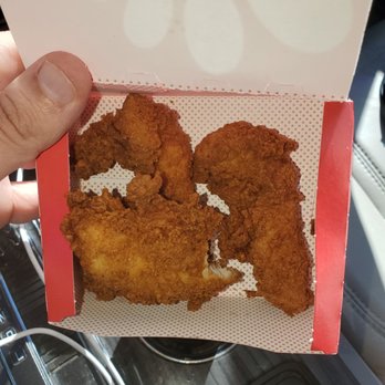 Chick-fil-A - ows a hand holding a box of chicken nuggies - Fast Food Near Me - Apple Valley, Minnesota
