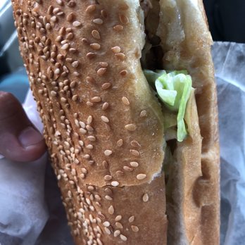 Zaghloul Subs - a person holding a sandwich - American Near Me - Dearborn Heights, Michigan Zaghloul Subs - a person holding a sandwich - American Near Me - Dearborn Heights, Michigan